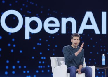 Sam Altman speaks at a technology industry event, photographed in close-up during a public appearance as OpenAI enterprise revenue sees growth
