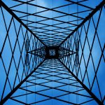 High-voltage transmission tower supplying electricity to data centers amid rising power demand from Big Tech’s AI infrastructure expansion.