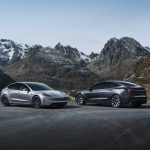 Tesla Model Y and Model 3 electric vehicles parked outdoors, as Tesla posts its first annual delivery decline in 2025 as EV demand slows and the company pivots toward energy storage and autonomous systems.