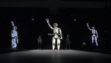 Hyundai Motor Group executives presenting Atlas humanoid robot and Physical AI strategy at CES 2026 in Las Vegas, as Hyundai plans to deploy Boston Dynamics’ Atlas humanoid robots in factories by 2028, partnering with Google DeepMind to commercialize physical AI at scale.