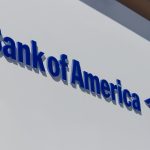 Bank of America logo on the exterior of a corporate office building, Bank of America posts a 12% profit increase as deposit growth and trading gains offset rate pressure, while regulatory uncertainty weighs on the sector.