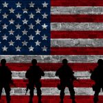 Dark silhouettes in front of the United States flag representing national security and military technology.