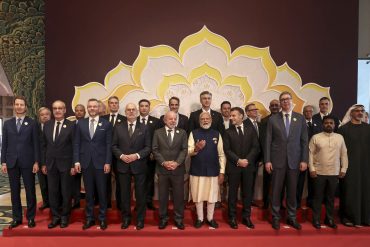 India Prime Minister Narendra Modi, Brazil President Luiz Inacio Lula da Silva and France President Emmanuel Macron pose with global leaders during the AI Impact Summit 2026 in New Delhi, highlighting multilateral AI policy coordination.