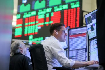 NYSE trader at the start of the week as US markets outlook shifts amid energy shock, private credit stress and tech liability pressures in 2026