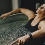 Woman wearing a Whoop fitness tracker during an ice bath recovery session as Whoop launches its women’s health biomarker panel, integrating wearable data with women’s health biomarkers.