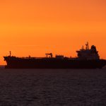 Oil tanker navigating the Strait of Hormuz as Brent crude prices surge above $90 amid escalating U.S.–Iran tensions.