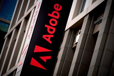 Adobe headquarters entrance and corporate signage in San Jose as the company announces strong Adobe Q1 2026 earnings, rising Creative Cloud revenue and accelerating adoption of Firefly generative AI tools.