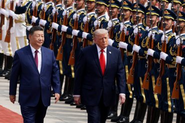 U.S. President Donald Trump reviews an honor guard alongside Chinese President Xi Jinping during the Trump Xi Beijing summit as U.S.-China trade talks, rare earth negotiations, AI competition, and semiconductor policy discussions dominate the agenda.