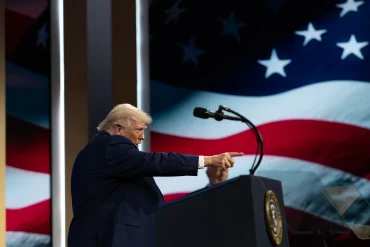 Donald Trump speaking at an event as US administration debates AI regulation and frontier AI oversight, focusing on AI security risks, policy shift, and government review of advanced AI capabilities