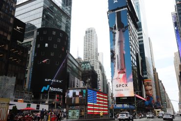SpaceX signage displayed at Nasdaq MarketSite during the company’s record $75 billion IPO and public market debut in New York.