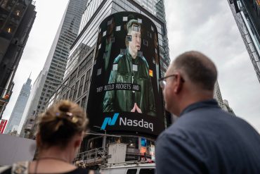 Elon Musk appears on a Times Square screen during SpaceX’s record IPO and Nasdaq debut in New York.