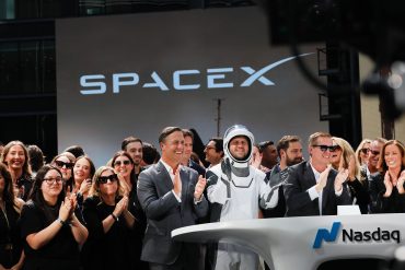 SpaceX employees celebrate the company’s Nasdaq debut following its record $75 billion IPO and market valuation above $2 trillion.