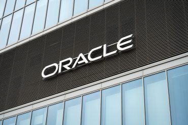 Oracle headquarters during Oracle layoffs and Oracle AI layoffs, highlighting AI job cuts, Oracle restructuring, Oracle 10-K disclosures, and cloud investment.