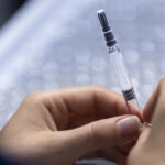Scientist holding a laboratory test tube during pharmaceutical research at Novo Nordisk, illustrating Ziltivekimab, ZEUS trial, IL-6 inhibitor research, cardiovascular inflammation therapy, heart disease treatment and clinical drug development.