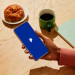 Hand holding a smartphone displaying the PayPal app as Stripe and Advent proposed a PayPal acquisition, highlighting digital payments, fintech, stablecoin payments, and the payments industry.
