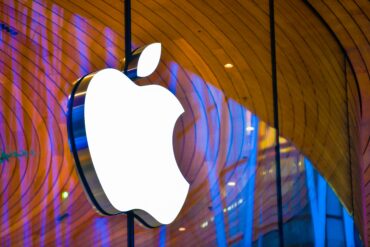 Apple Store facade with Apple logo representing Apple Q3 earnings, strong iPhone revenue performance, China weakness, services concerns, and rising memory costs affecting margins.