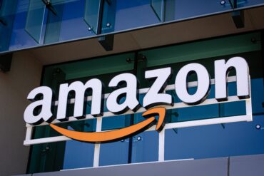 Amazon office building representing Amazon AWS growth, AI investment strategy, cloud business expansion, Anthropic gains, and rising infrastructure costs affecting cash flow.
