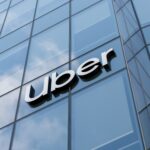 Uber corporate branding on the building representing the company's mobility and delivery platform following strong Q2 earnings, record Gross Bookings, Delivery Hero acquisition plans and continued investment in autonomous vehicle technology.