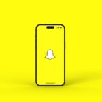 iPhone displaying the Snapchat logo, illustrating Snap Q2 earnings, Snap profitability, revenue growth, free cash flow, Specs AR glasses strategy and Snap financial results as the company expands its advertising and augmented reality business.