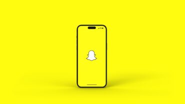 iPhone displaying the Snapchat logo, illustrating Snap Q2 earnings, Snap profitability, revenue growth, free cash flow, Specs AR glasses strategy and Snap financial results as the company expands its advertising and augmented reality business.