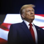 President Donald Trump responding to Dario Amodei's AI slowdown call, dismissing frontier AI safety concerns as a hoax amid debate over AI regulation and Nvidia stock