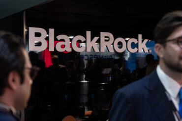 BlackRock logo on an office wall representing BlackRock Q3 earnings, record assets under management, rising profit, private markets growth and stronger fee revenue