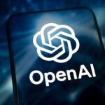 Mobile phone displaying the OpenAI logo representing the OpenAI security breach, insider threat, wiretap case, employee arrest and protection of sensitive AI research