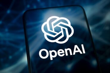 Mobile phone displaying the OpenAI logo representing the OpenAI security breach, insider threat, wiretap case, employee arrest and protection of sensitive AI research