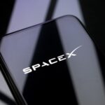 Mobile phone displaying the SpaceX logo, representing the SpaceX spectrum deal, Starlink Mobile, 800 MHz low-band spectrum, direct-to-device service and U.S. wireless competition