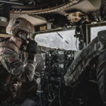 Military personnel operating tactical communications equipment, representing RTX defense technology, RTX raised 2026 outlook, Collins Aerospace TruNet systems and growing military demand
